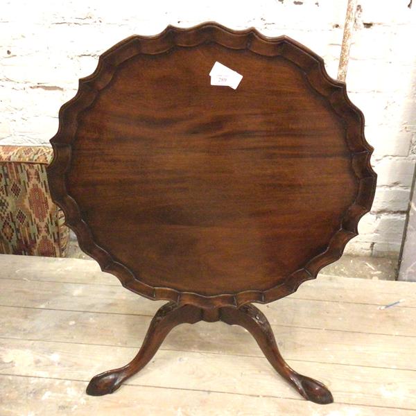 A reproduction Georgian style tilt top occasional table, with circular scalloped piecrust top, on