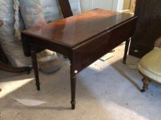 A mid 19th century mahogany drop leaf dining table, the rectangular moulded top raised on ring