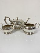 An Epns three piece tea service complete with cream jug and sugar basin, with teapot