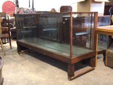 An early 20th century glazed oak haberdashers counter, the interior fitter with two glass shelves,