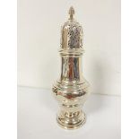 A Chester silver domed sugar castor with pierced top and tapered acorn style finial, raised on