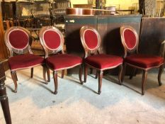 A set of four Victorian mahogany dining chairs, with upholstered seat and back, raised on cabriole