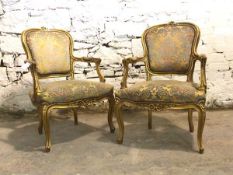 Pair of 20th century giltwood Fauteuil chairs, floral carved crest rail over floral upholstered