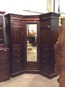 An Edwardian stained pine corner wardrobe, dentil cornice over central mirrored door enclosing