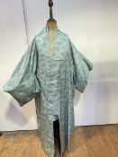 A Japanese silk kimono with stylised sunburst or chrysanthemum design, in mint and dark green,