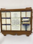 An Edwardian oak framed presentation sample cabinet, the bleached calico by Rylands & Son Ltd. Grand