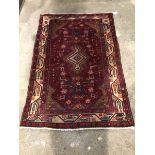 Persian Hamadan design red ground rug, with geometric design and bordered 152cm x 101cm