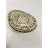 A Continental white metal snuff box of curved oval form with engraved hinged top, with cypher CJ (
