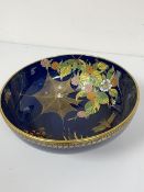 A Carltonware lapis blue ground enamel decorated bowl with butterfly and spider design (10cm x d.