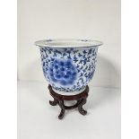 A modern Chinese blue and white decorated jardiniere with stylised crysanthemum and leaf design (