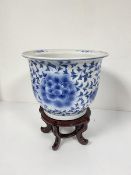 A modern Chinese blue and white decorated jardiniere with stylised crysanthemum and leaf design (