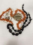 A French jet graduated bead necklace and a coral thong necklace, a white metal chain, an enamelled