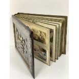 A Japanese lacquered and mother of pearl mounted photograph/postcard album containing a large