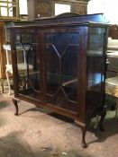 An Edwardian mahogany display cabinet, the shaped raised back over a rectangular moulded top, two