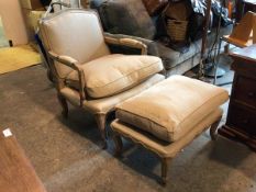 A French Fauteuil chair and footstool, each with limed beech frame and upholstered in a natural