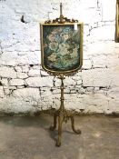 19th century Rococo style giltwood and gesso pole screen, the glazed floral paper banner on a