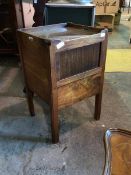 A 19th century mahogany night commode, the tray top with pierced handles over a tambour fronted