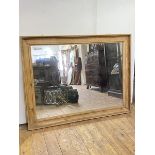 A large rectangular wall hanging mirror, enclosed by a cavetto moulded reclaimed pine frame H97cm