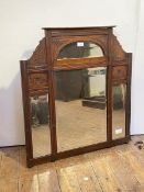 An Edwardian walnut framed wall hanging mirror, sectional bevelled glass enclosed by frame with