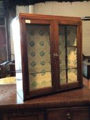 A 20th century mahogany tabletop showcase, two glazed doors enclosing single shelf, H70cm, W62cm,