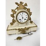 A 19thc alabaster metal mounted drum head clock with enamelled dial and twin key apertures, complete