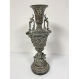 An Egyptian revival cast brass two handled urn decorated with lotus leaf and flower design and