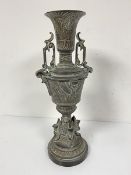 An Egyptian revival cast brass two handled urn decorated with lotus leaf and flower design and