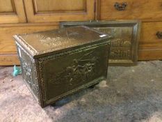 A hammered brass coal box, the exterior decorated with coaching scenes, the hinged lid revealing a