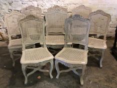 A Set of eight (4+4) French style hardwood dining chairs, floral carved crest rail over cane seat