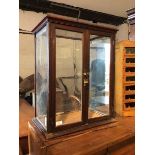 A Victorian mahogany table top show case, with two glazed doors enclosing opaline glass panel to top