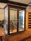 A Victorian mahogany table top show case, with two glazed doors enclosing opaline glass panel to top