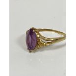 A 14ct gold marquise cut amethyst dress ring with diamond points to each shoulder in Art Nouveau