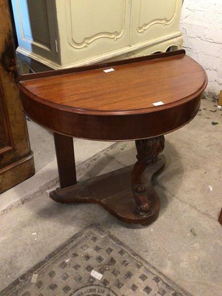 A Victorian mahogany bowfront side table, the raised back over top with moulded edge and scroll