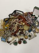 A collection of costume jewellery including paste pearls, bead necklaces, brooches, white metal ring