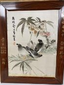 A Chinese silk embroidered panel depicting three birds, signed, stained frame signed in gilt in