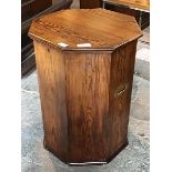 An early 20th century pitch pine lidded pedestal of octagonal form, with baize lined interior and