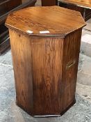 An early 20th century pitch pine lidded pedestal of octagonal form, with baize lined interior and