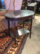 An Edwardian mahogany oval centre table, the top raised on square tapered supports united by under