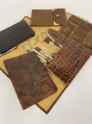 A vintage imprinted crocodile skin manicure set, four various leather wallets etc. (a lot)