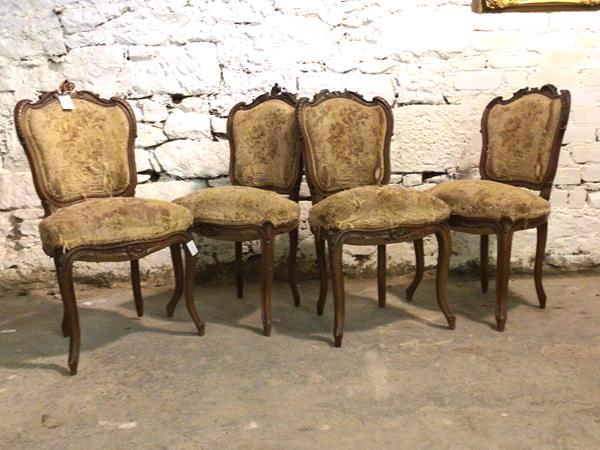 A set of four 19th century French walnut side chairs, with floral carved crest rail, tapestry