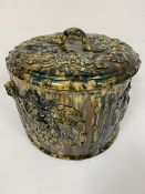 A Methven style pottery grape container decorated with vine leaves and fruit, with twin handles to