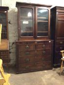 A 19th century mahogany bookcase on chest, the associated top with two glazed doors enclosing