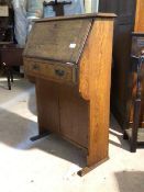 An early 20th century Arts and Crafts period oak bureau, the fall front revealing fitted interior