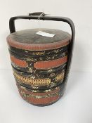 A Chinese black lacquered and gilt decorated food container fitted three sections, complete with lid