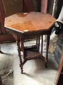 A late Victorian walnut centre table of octagonal outline with turned supports united by a galleried