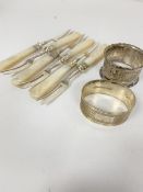 A Birmingham silver oval engine turned decorated napkin ring and a chased Birmingham silver napkin