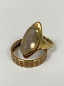 A 9ct gold navette shaped moonstone ring mounted in rubover setting (J/K) and a 9ct gold engraved