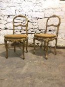 A pair of 19th century French giltwood side chairs, floral carved crest rail and scrolled rail