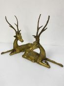 A pair of cast brass Thai style seated deer figures (33cm x 34cm)