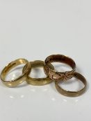 A collection of four various wedding bands, one with hammered finish, one with engraved design to